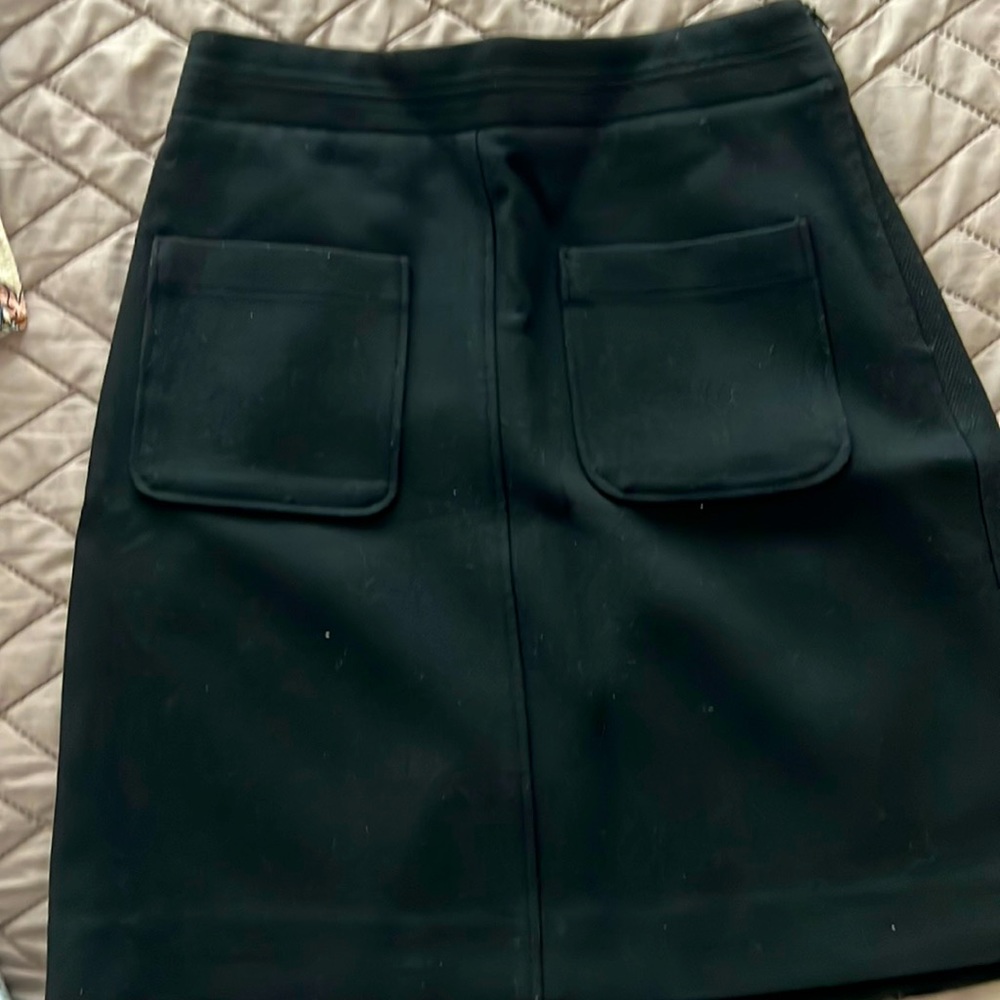 Mid thigh length Aline skirt with front pockets.